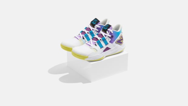 Side view of Coco Gauff's white and purple New Balance tennis shoes.